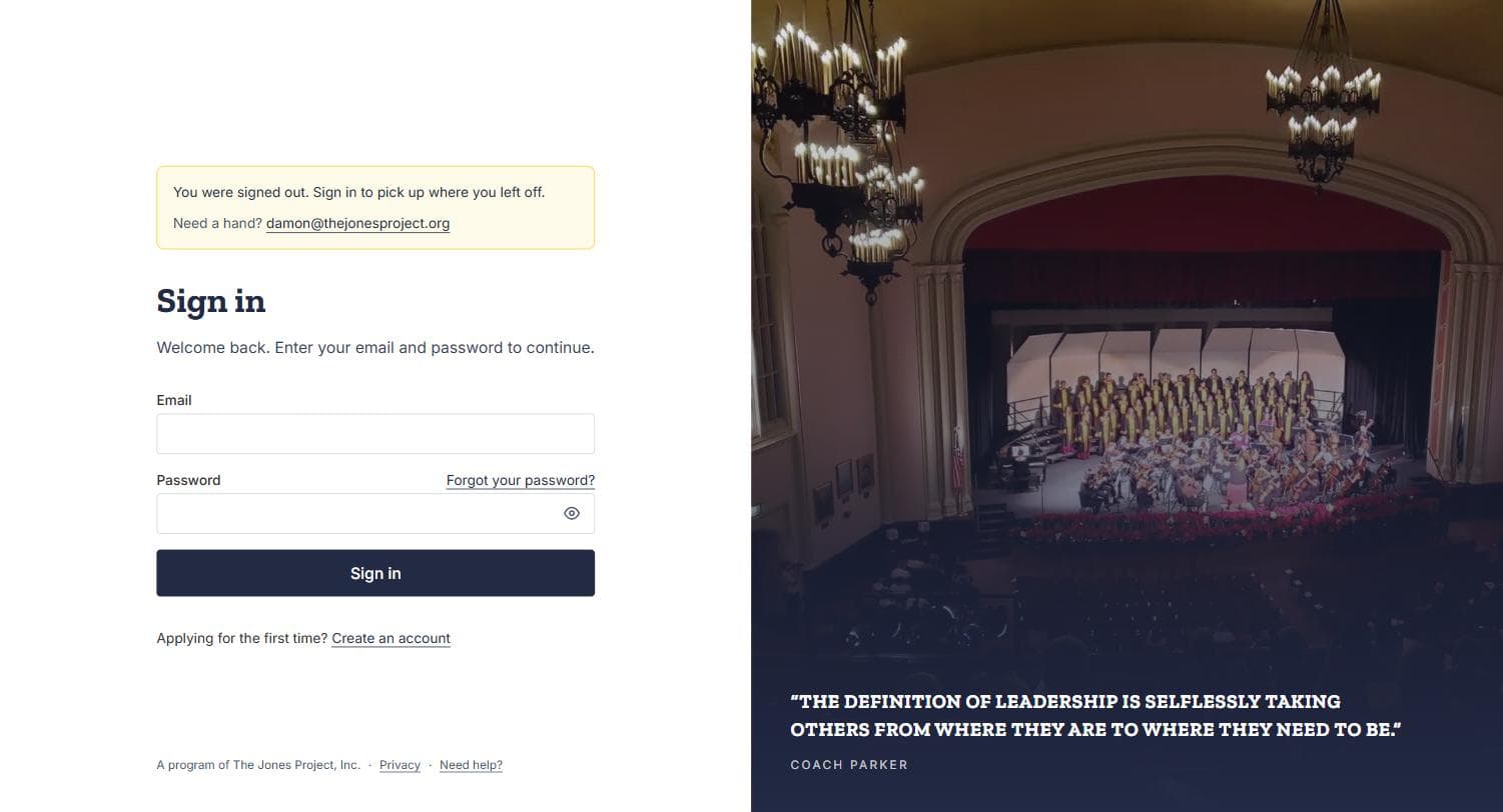 The sign-in screen, with email and password fields beside a photograph of an auditorium.